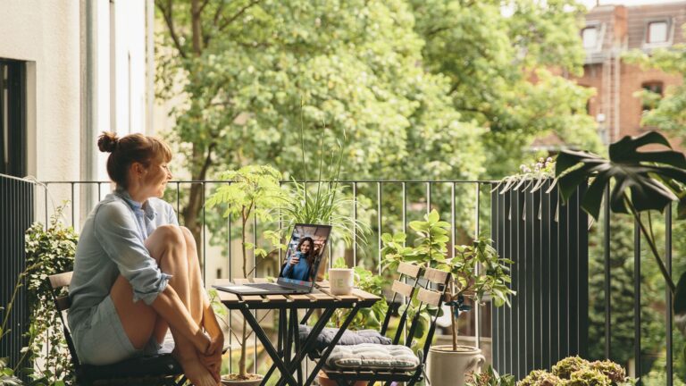 Someone watching at a Acer laptop. Outside, in a green environment.
